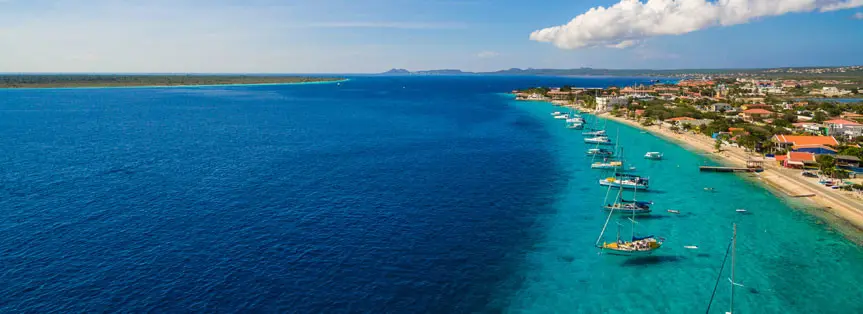 Boats docked at the edge of a small island.